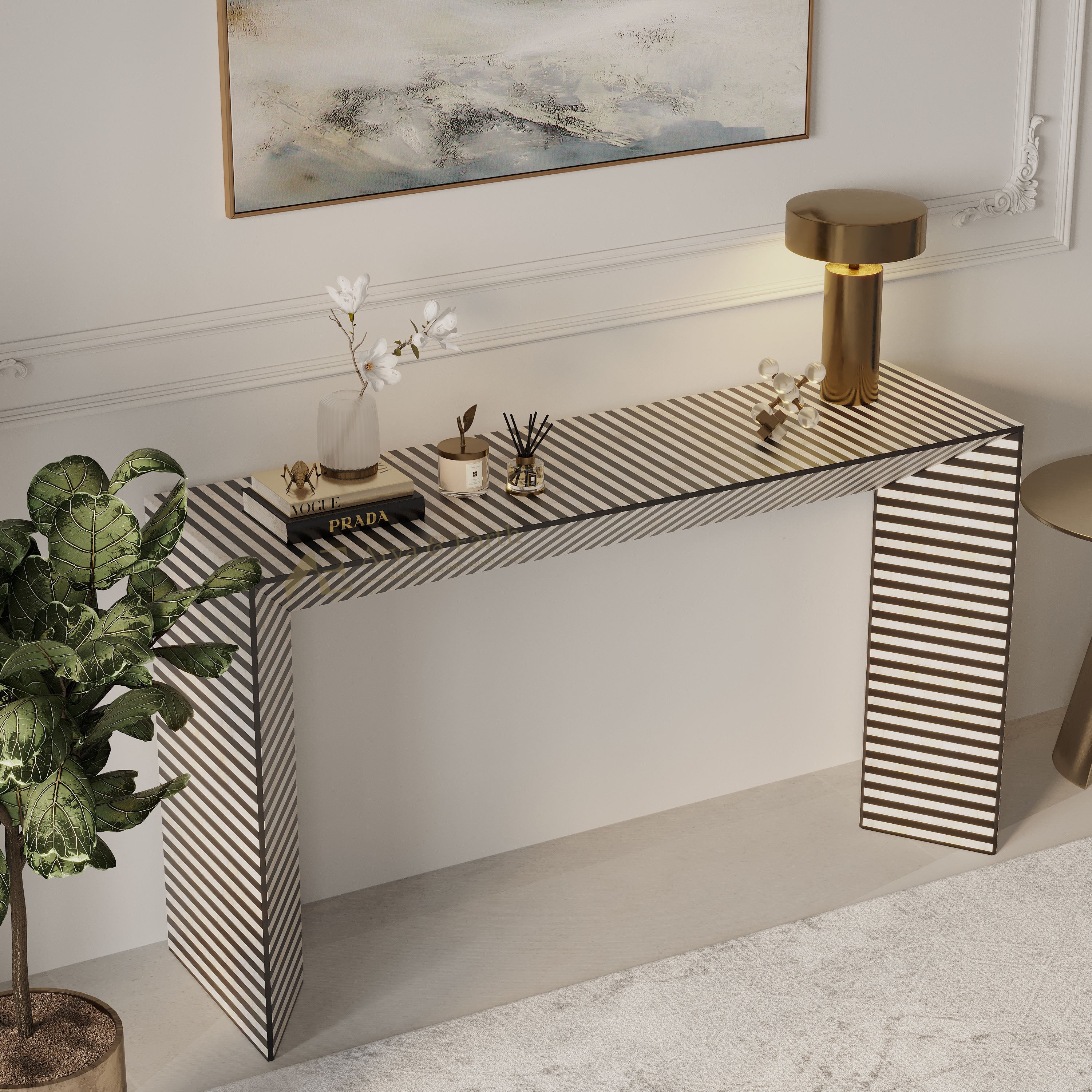 A modern console table with a black and white striped pattern, styled in a bright, elegant room with a gold table lamp, books, and a vase of white flowers.
