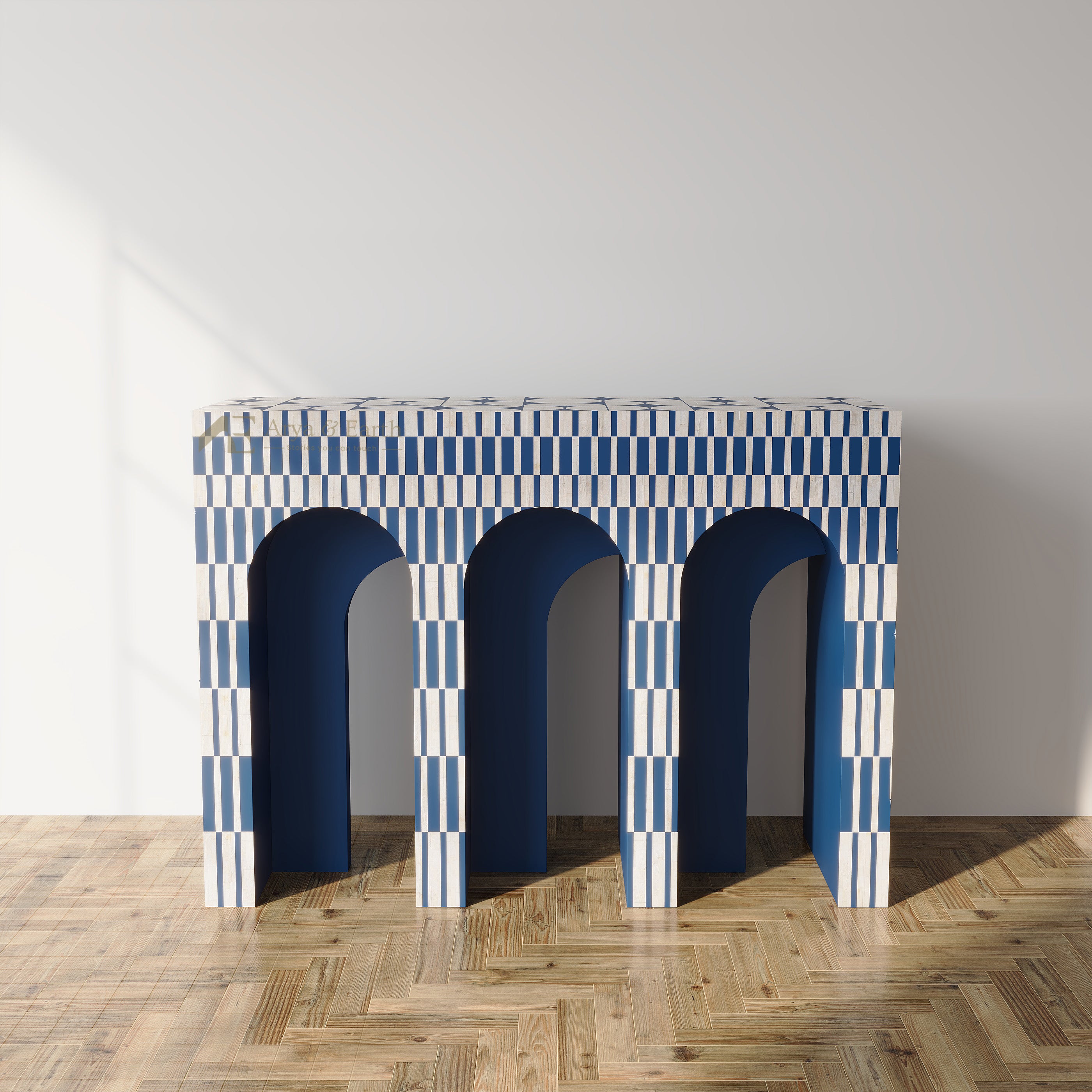 A modern console table with three arches, featuring a blue and white striped checkerboard pattern on the top and legs, and solid dark blue interiors, set against a minimalist white wall and light wood parquet floor.