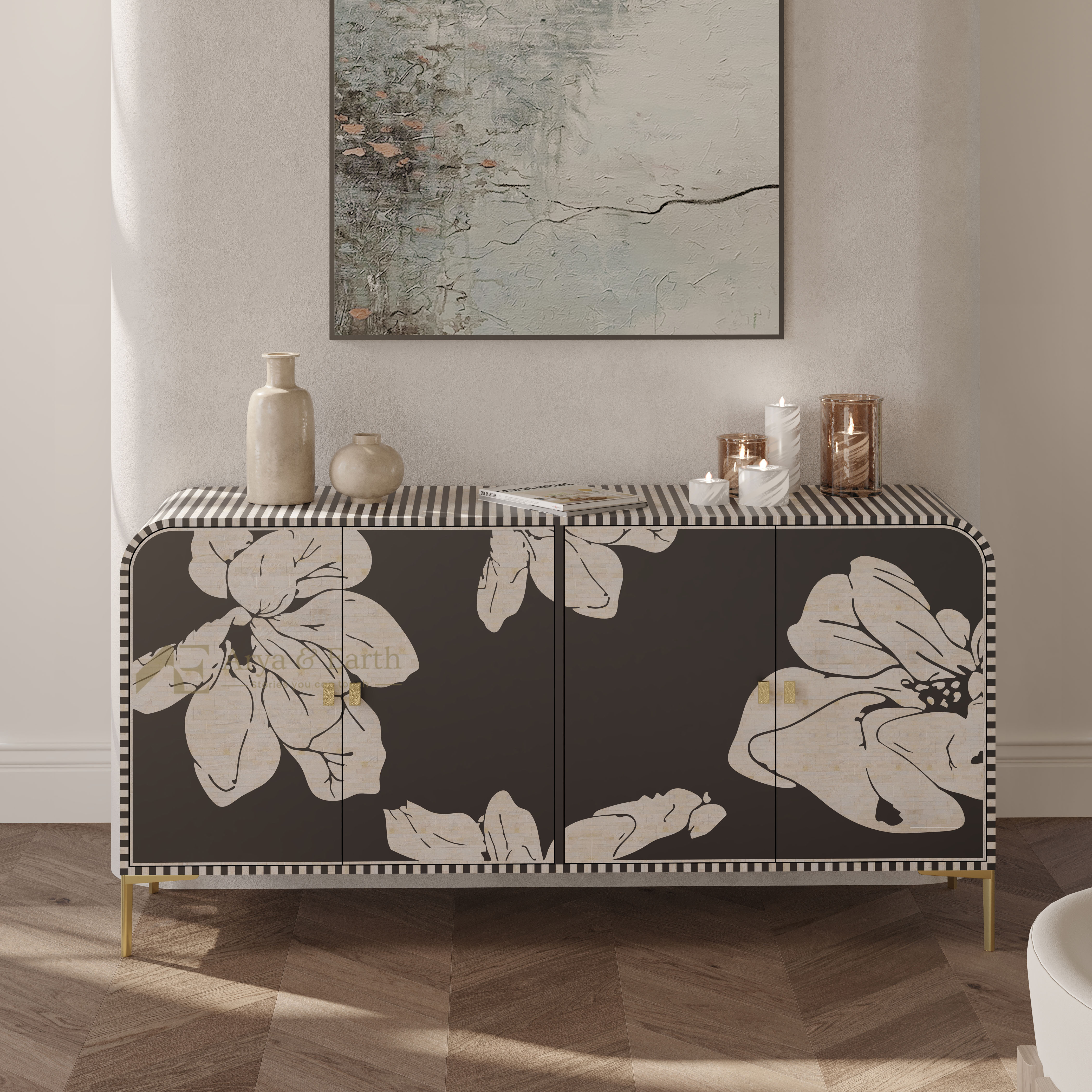 A dark gray sideboard cabinet with large cream floral prints and gold legs, styled in a modern living room setting with decorative vases and candles on top.