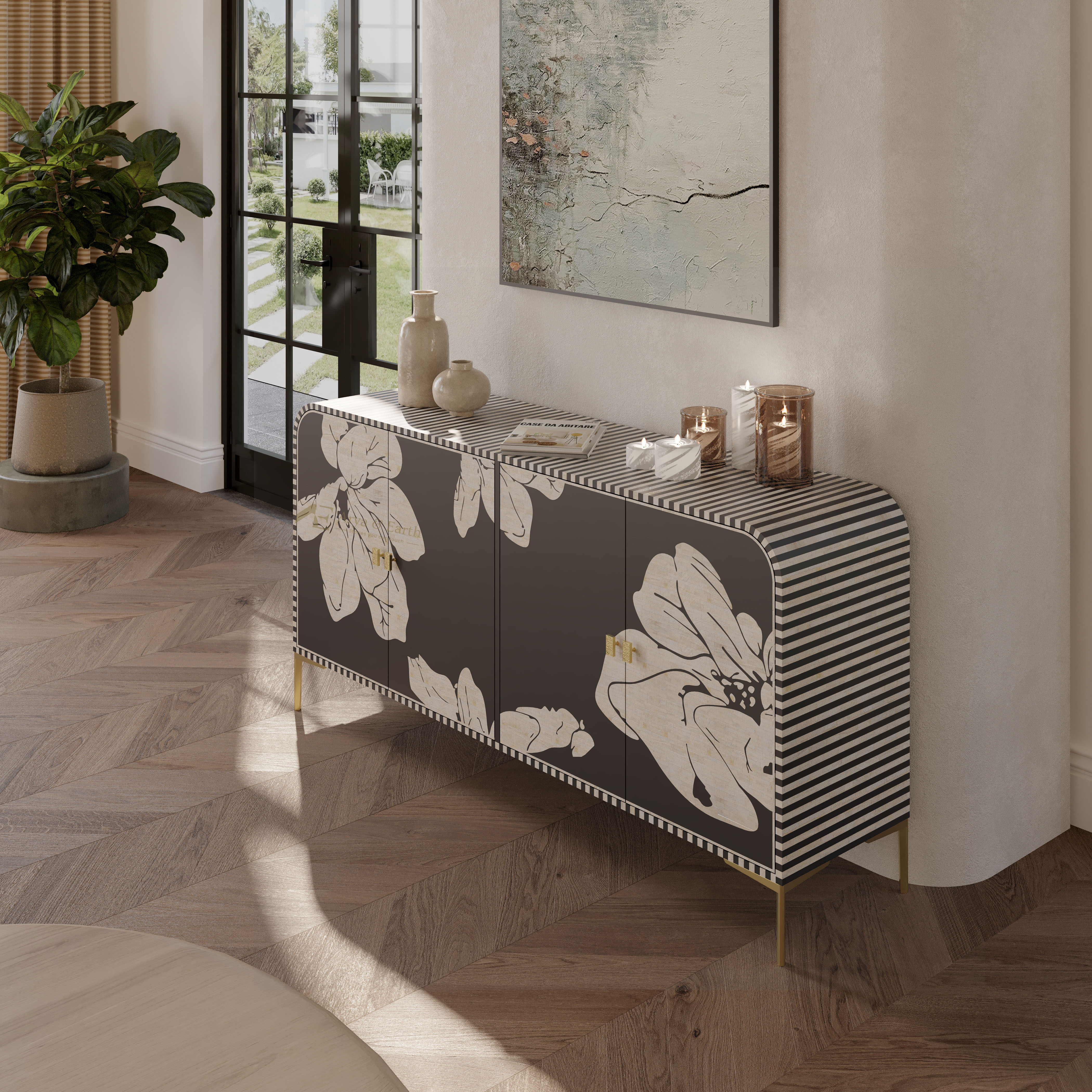 A modern sideboard cabinet in a styled interior room, featuring a dark charcoal front with large cream floral motifs, black-and-white striped side panels, and slim gold legs.