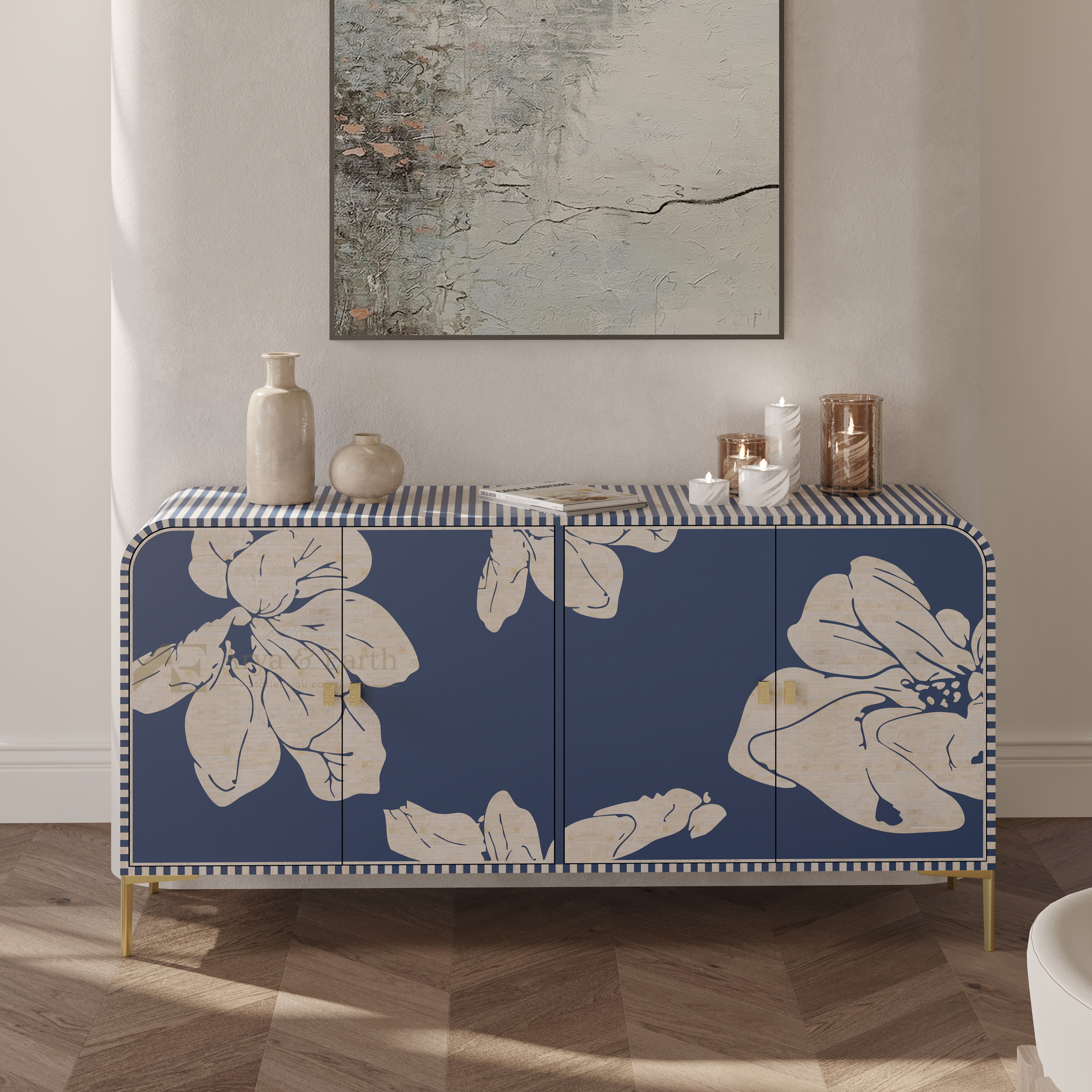 A blue sideboard cabinet with large cream floral prints and a striped top, styled in a modern living room setting with decorative vases and candles.