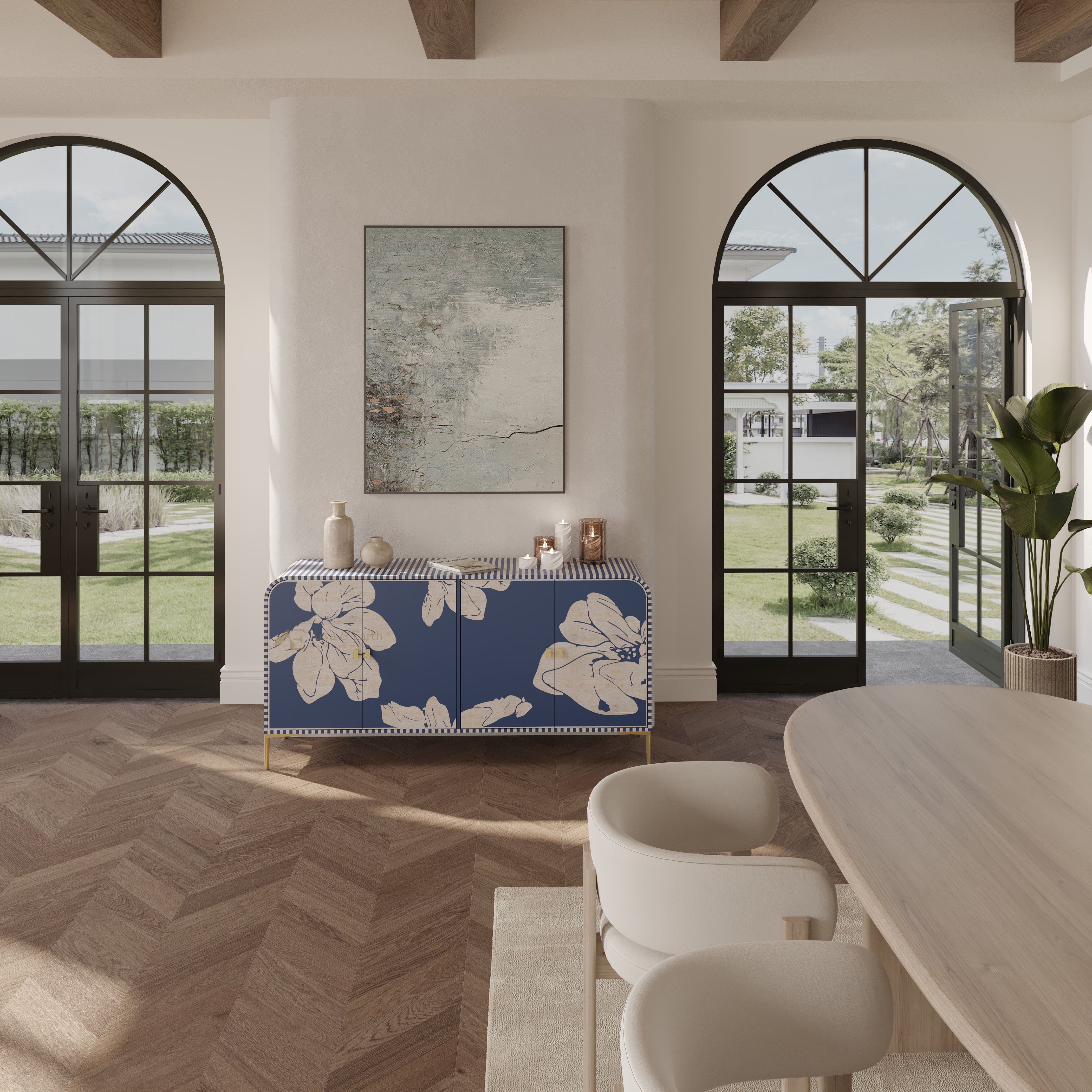 A blue and beige floral sideboard cabinet in a bright, modern dining room with herringbone wood floors, arched windows, and a light wood dining table.