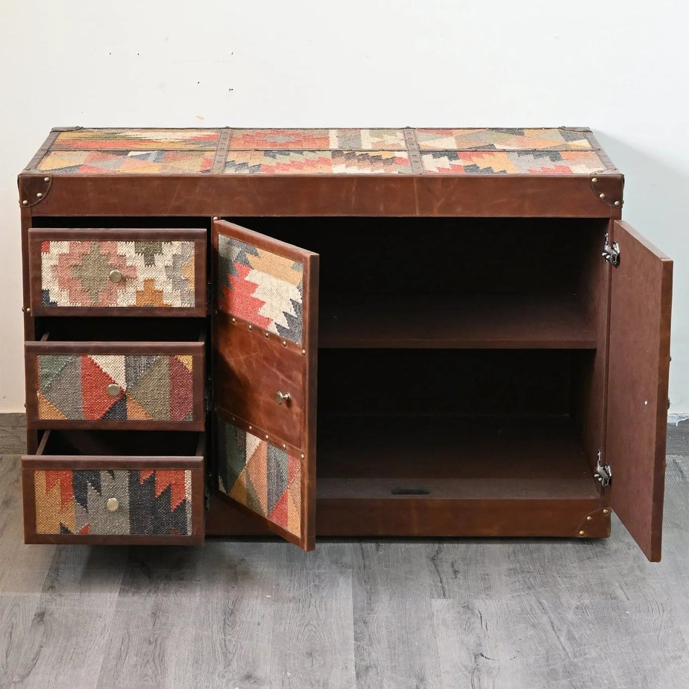 Wooden cabinet with patchwork design on a white wall background