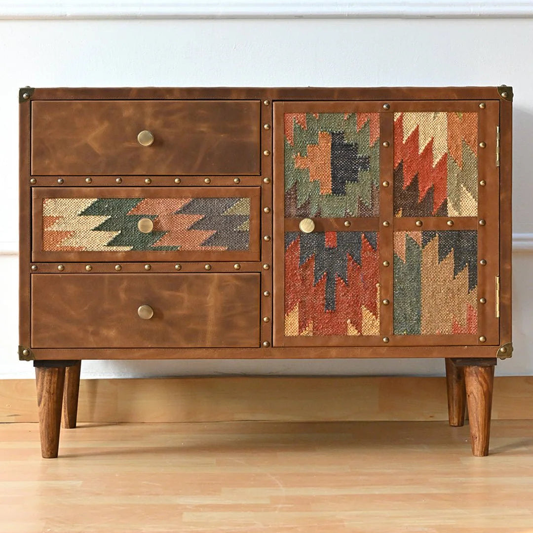 Wooden dresser with geometric patterned doors on a wooden floor.