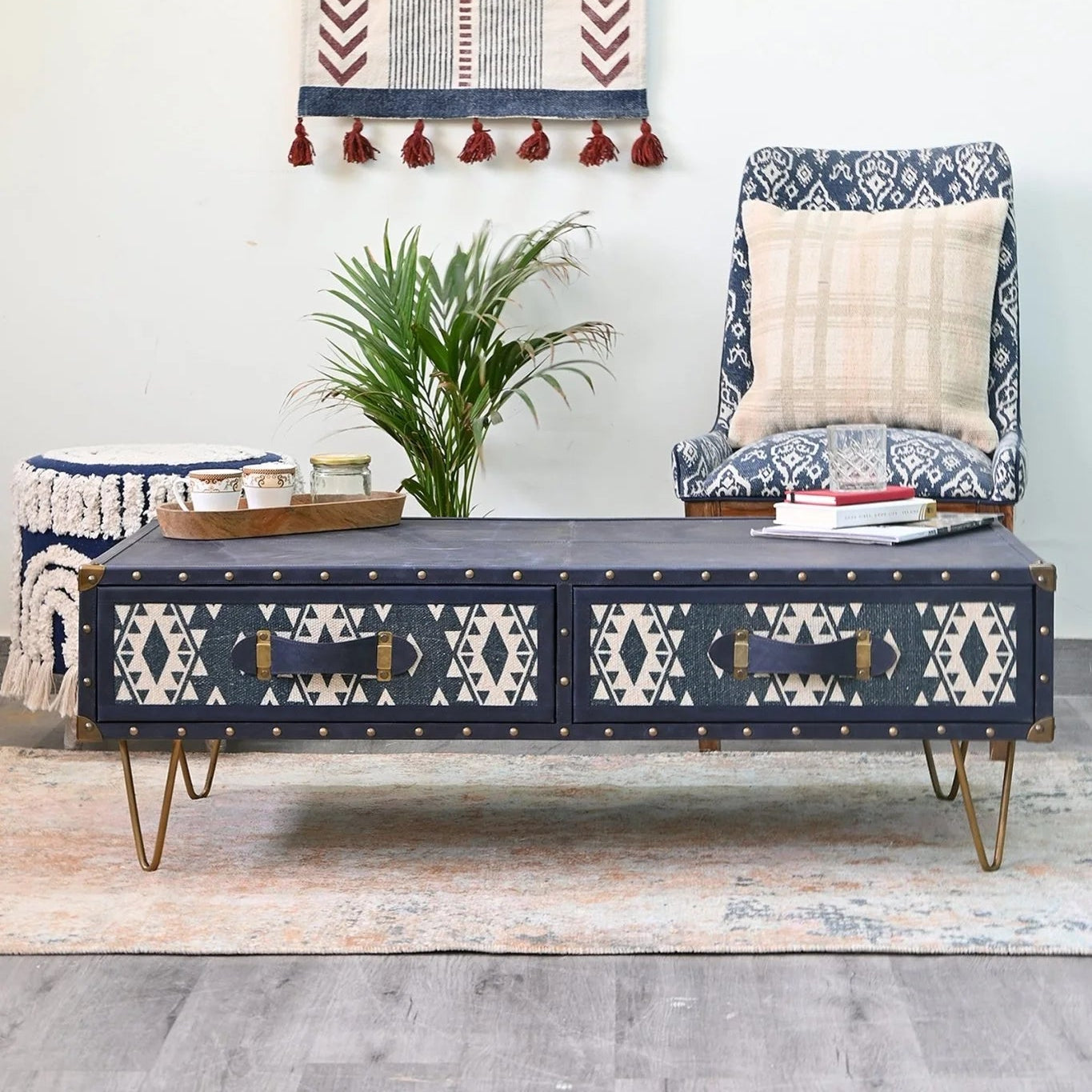 Navy and white patterned wall hanging above a bench with geometric design, in a room setting.