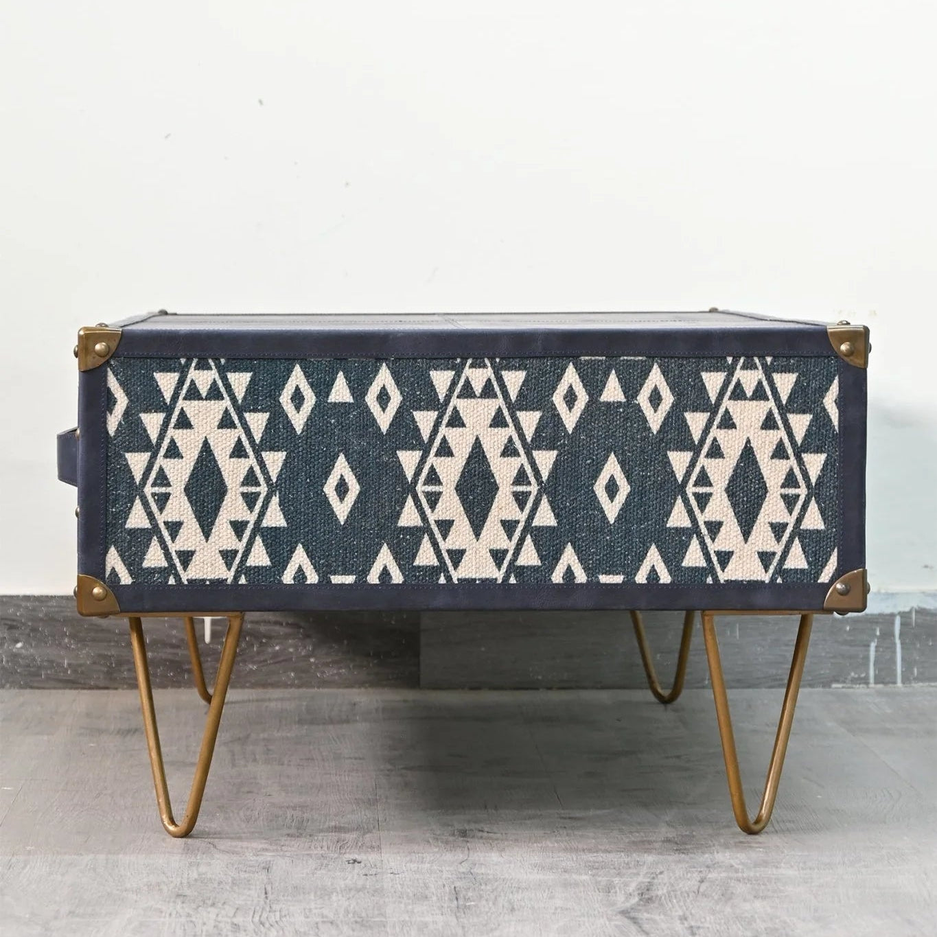 Coffee table with geometric pattern on a gray floor