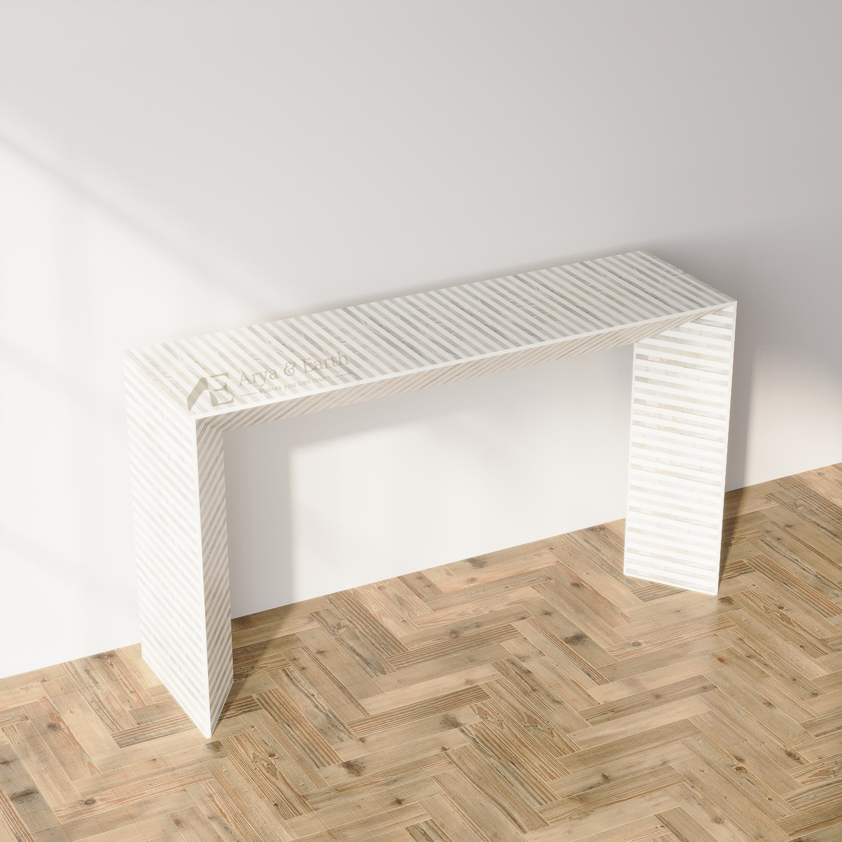 A modern white console table with a ribbed, striped texture, shown in a minimalist room setting with a light gray wall and a light wood herringbone floor.