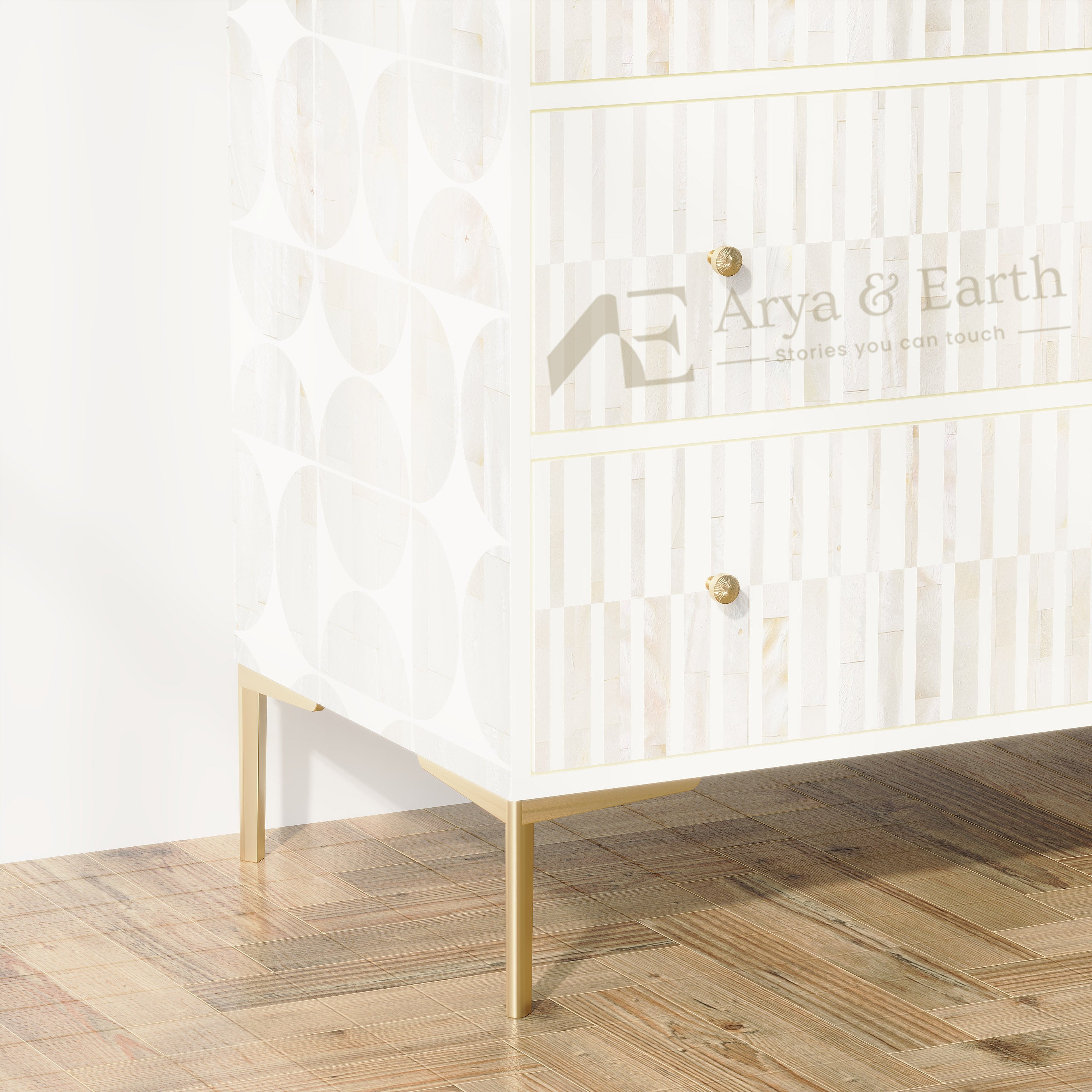 A white wooden chest of drawers with gold legs and gold knobs, featuring a geometric pattern on the side panel and a vertical striped design on the drawer fronts. The brand name 'Arya & Earth' is printed on the front.