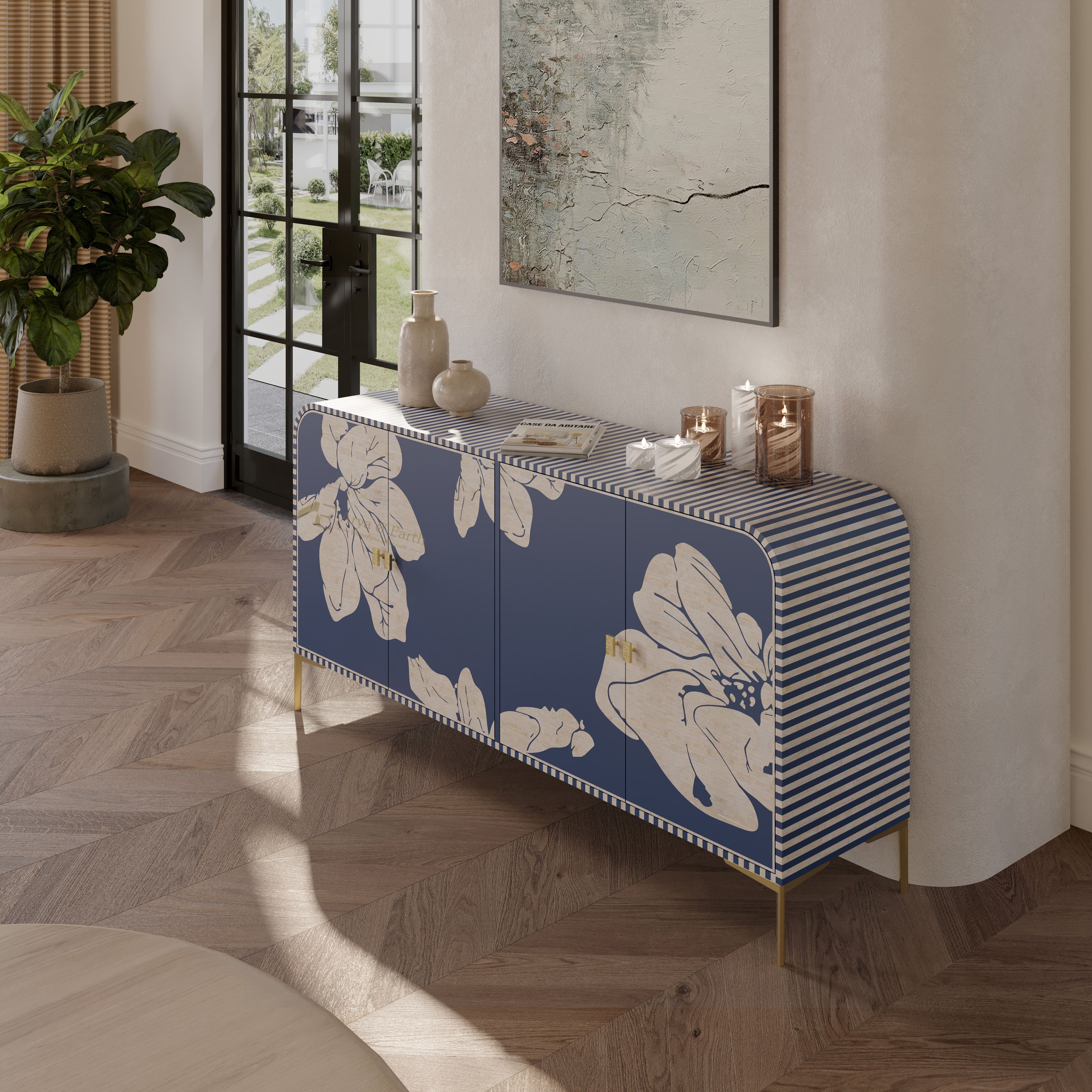 A blue and white striped sideboard cabinet with large white floral motifs on the front, styled in a modern living room setting with a herringbone wood floor and neutral walls.
