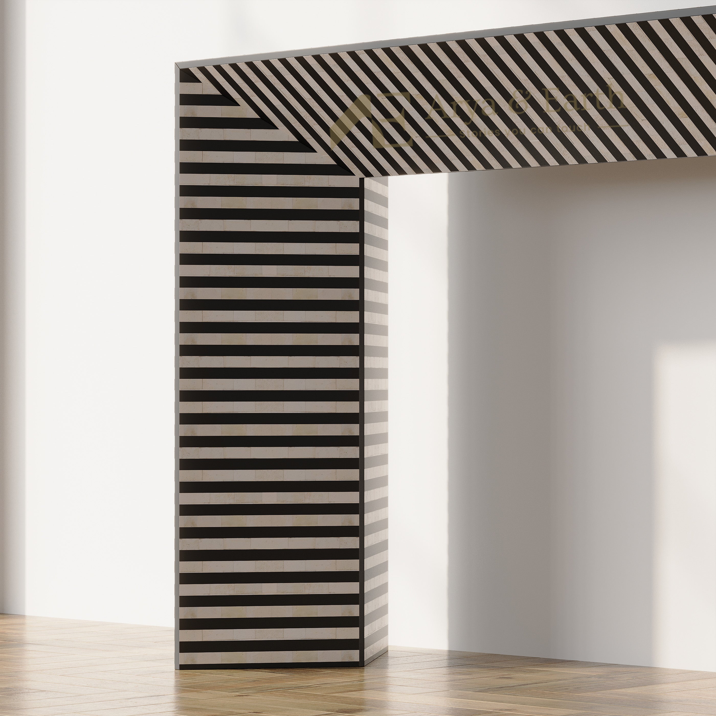 A modern L-shaped console table with a bold black and beige striped pattern, set in a minimalist room with light-colored walls and a wooden floor.