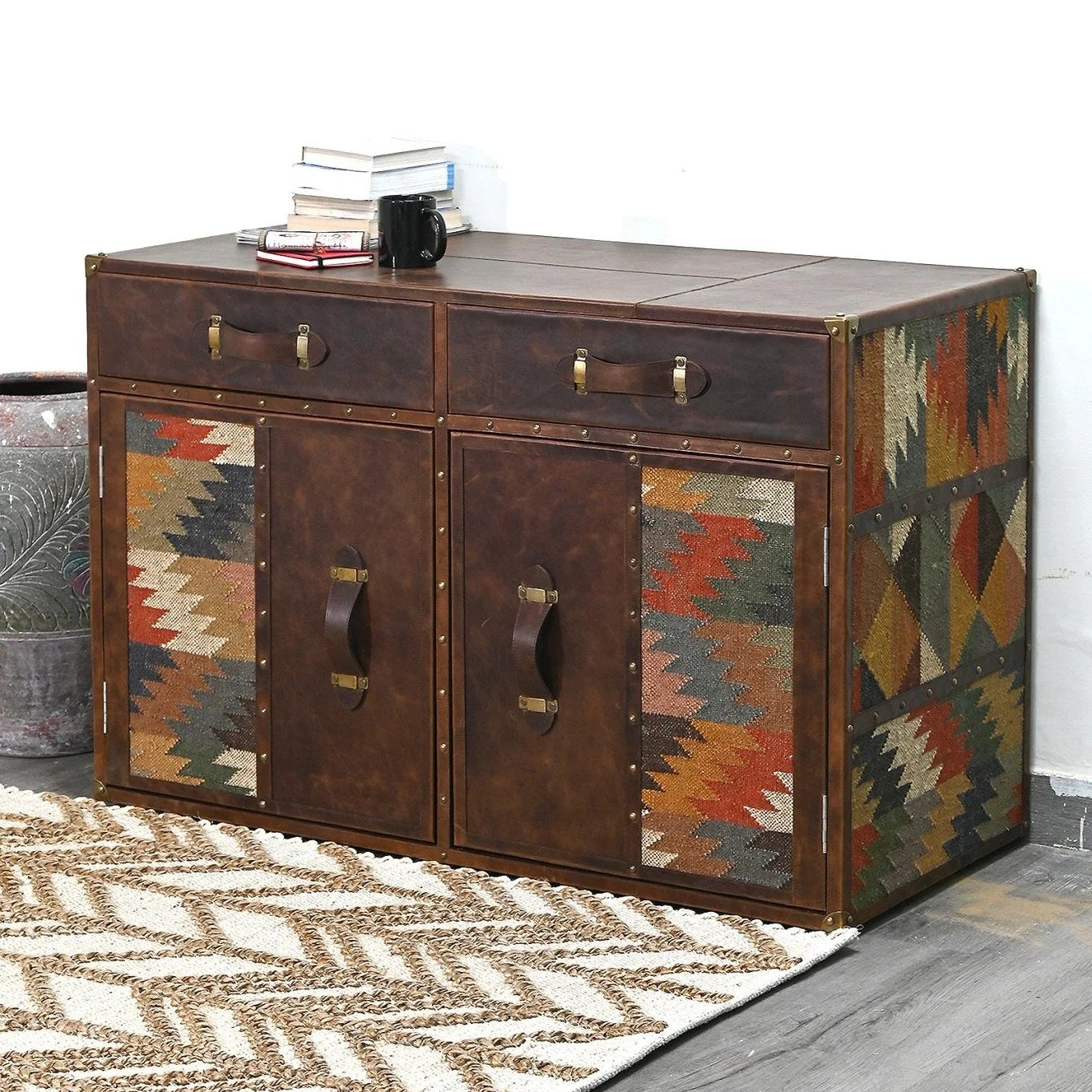 Wooden sideboard with geometric patterned doors on a gray floor.