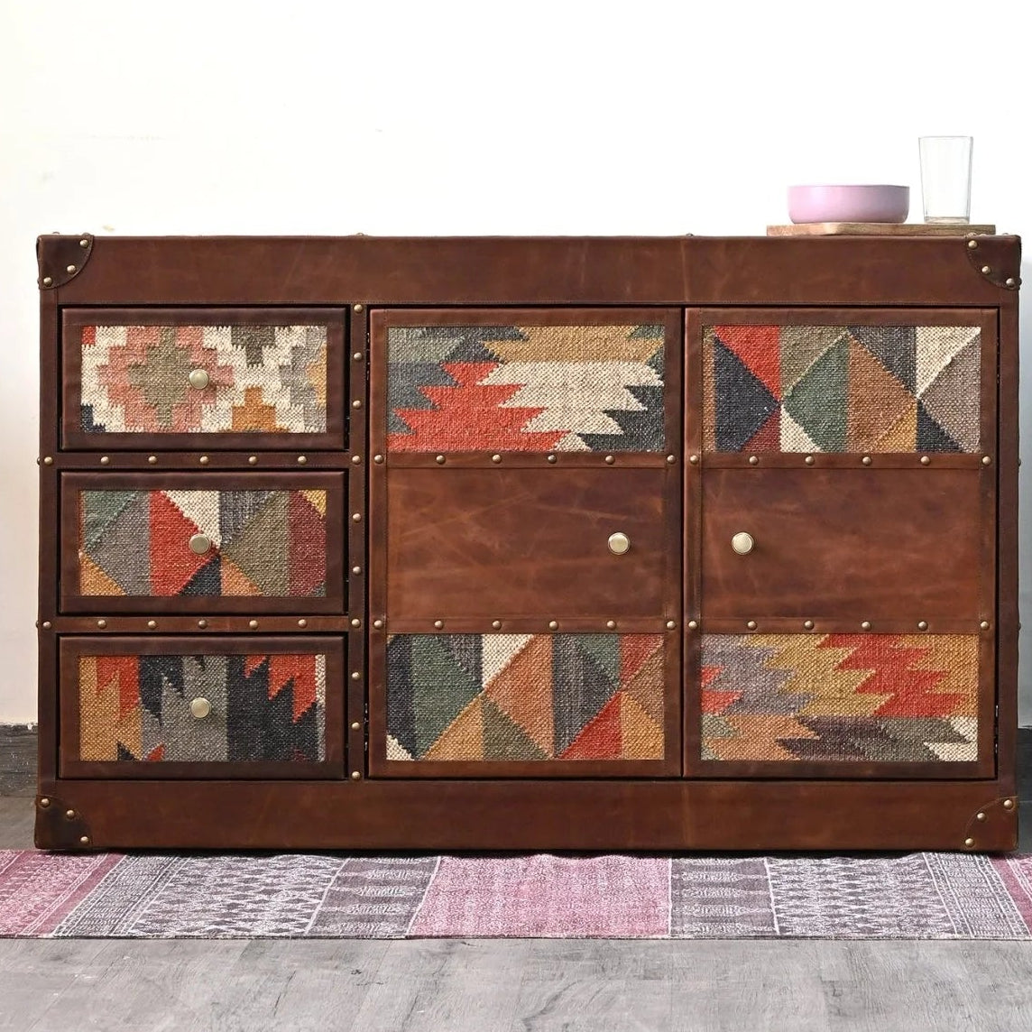 Wooden cabinet with patterned doors in a room setting