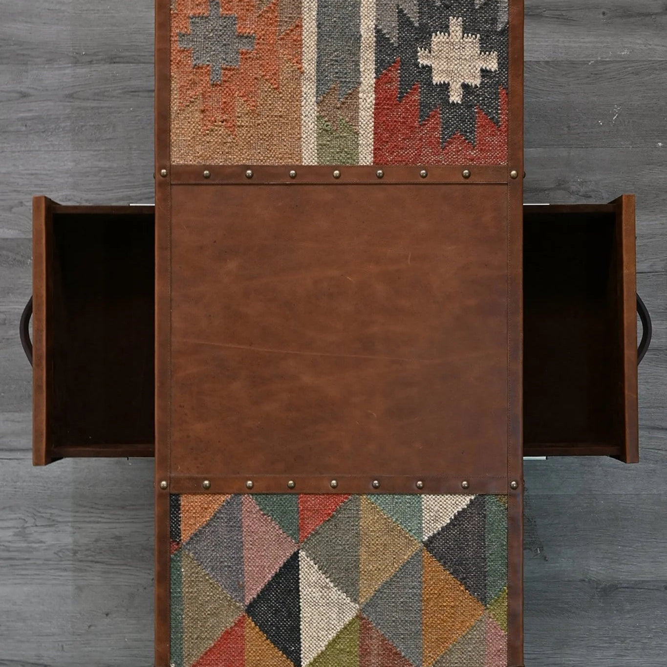 Brown wooden sideboard with geometric patterned doors on a gray background