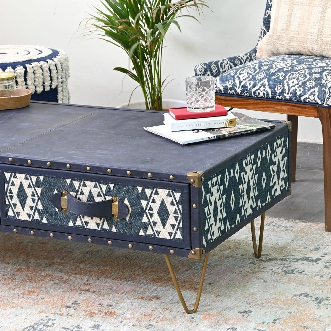 Navy blue coffee table with white geometric patterns in a living room setting.