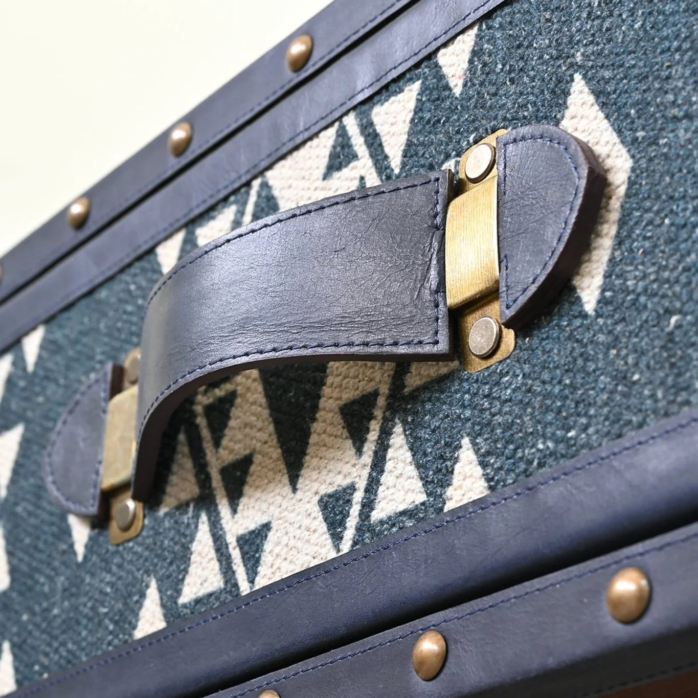 Close-up of a coffee table handle with geometric patterned fabric