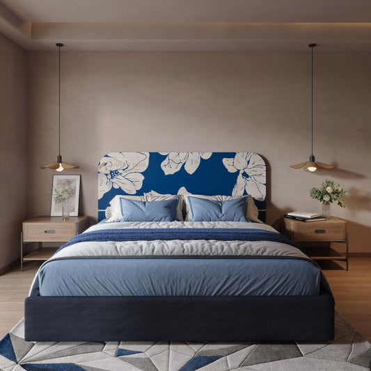 Modern bedroom with a blue floral headboard and matching bedding.