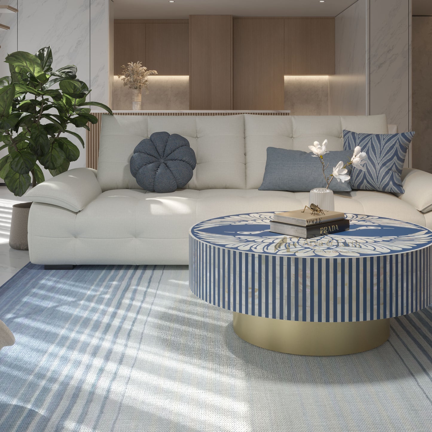 Modern living room with a white sofa, decorative pillows, and a round coffee table with a blue and white stripes.