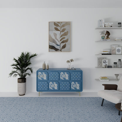 Blue chest of drawers with white floral patterns in a modern living room setting.