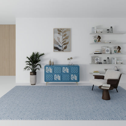 Modern living room with a blue rug, white walls, and sideboard with drawers