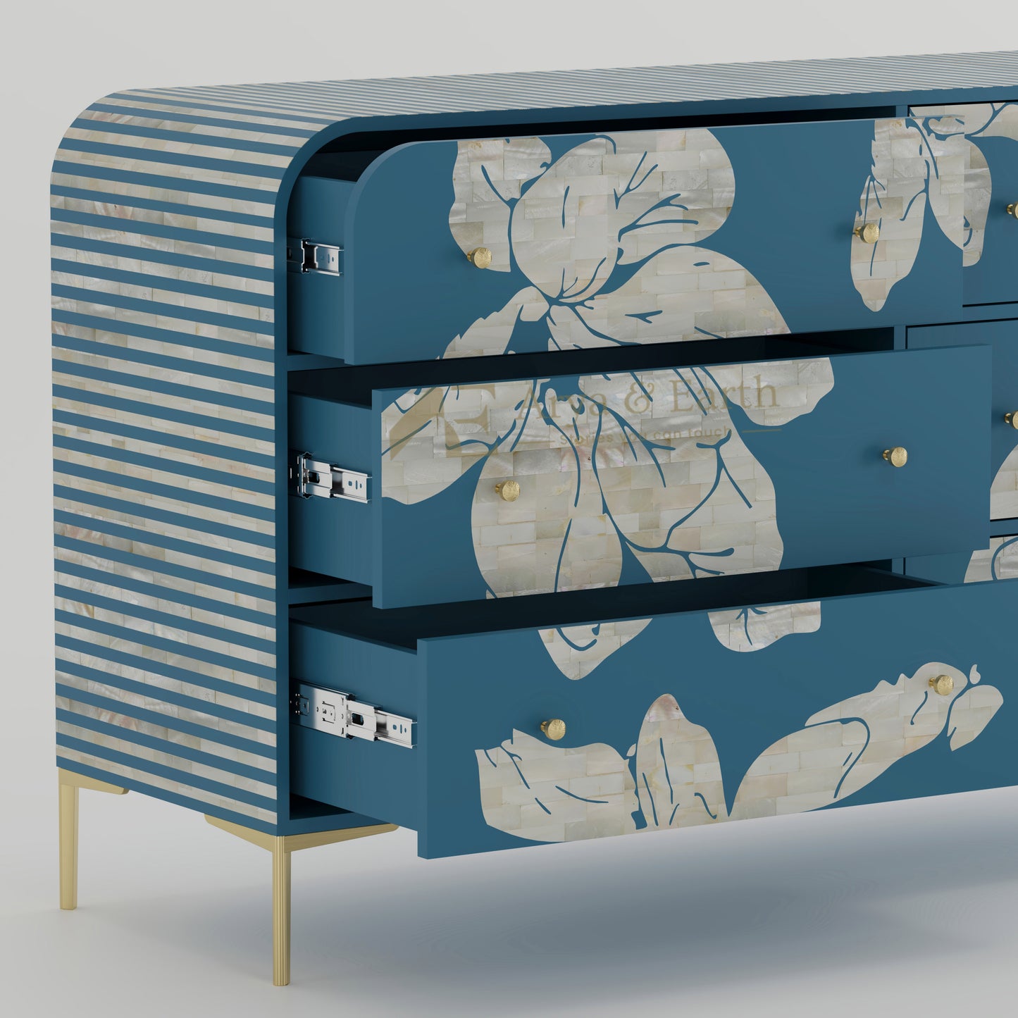 Open drawers on blue chest of drawers with floral patterns and striped sides