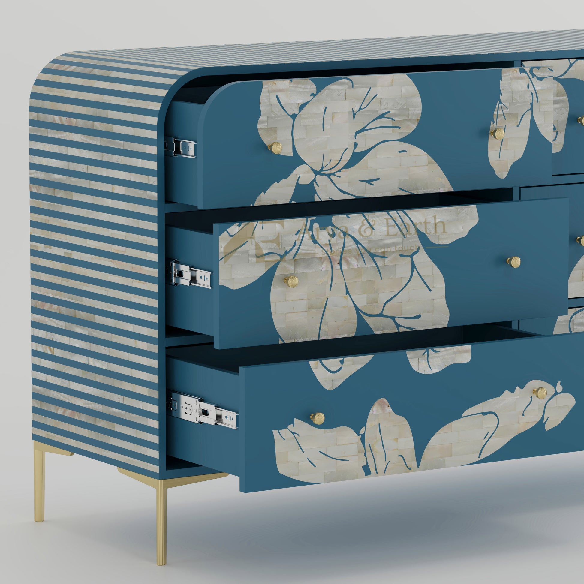 Open drawers on blue chest of drawers with floral patterns and striped sides