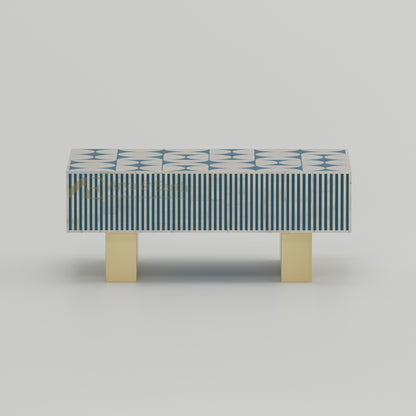 Coffee table with blue and white geometric pattern.