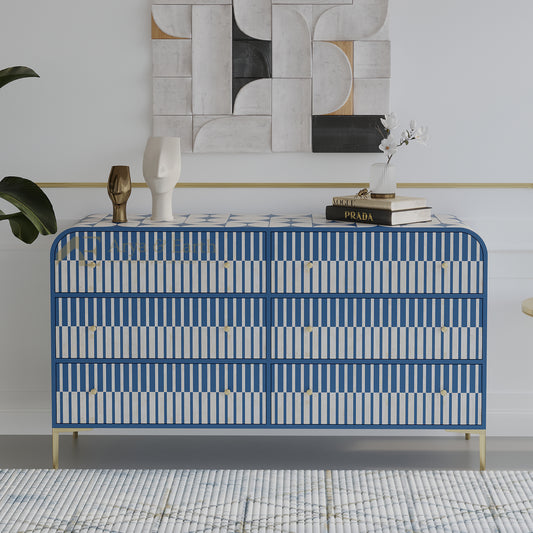 Blue and white patterned dresser in a room with abstract wall art