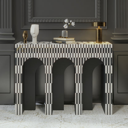 Bone inlay console table with black and white checkered pattern against a dark wall.