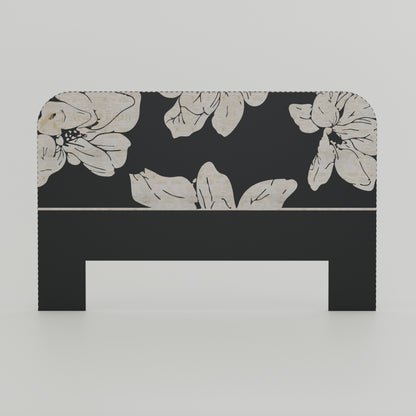 Black headboard with floral pattern on a white background