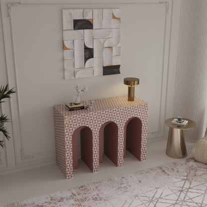 Patterned side table with arched design in a room with abstract wall art and gold accents.
