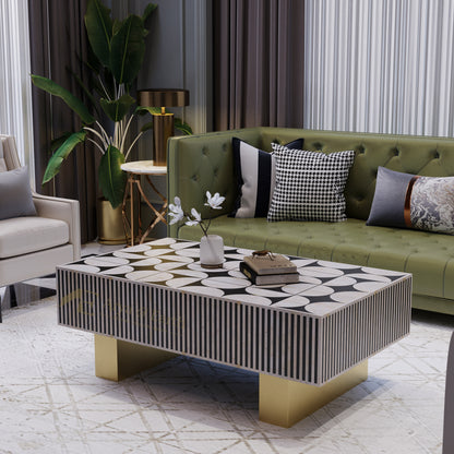 Modern living room with a green sofa, bone inlay monochromatic coffee table, and decorative pillows.